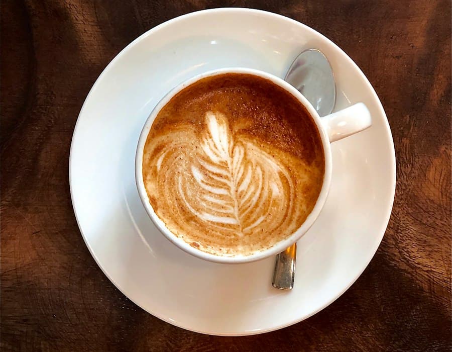 Cappuccino with leaf latte art, seen from above