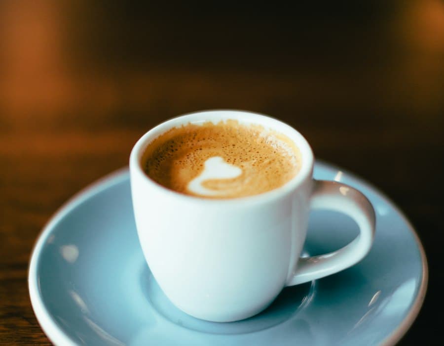Espresso in a white cup on a blue saucer